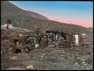 Image of Rock-Sod Igloo [Typical West Greenland home, Rock and Sod home. Miriam walking in back]